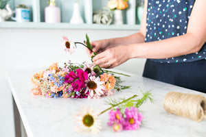 Toronto florist Jess McEwen is making a flower bouquet for delivery