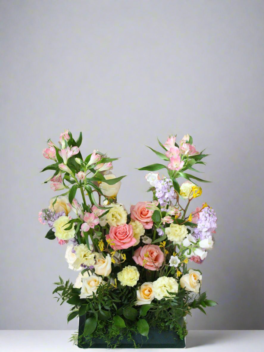 A flower arrangement sits on the floor.